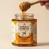 Wholly Forest Himalayan Raw Multiflora Honey 350g hexagonal glass jar with golden honey drizzling from a wooden dipper